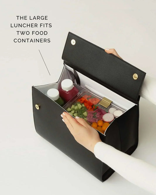 Black insulated lunch bag holding two food containers with fresh veggies and drinks, perfect for work or travel.