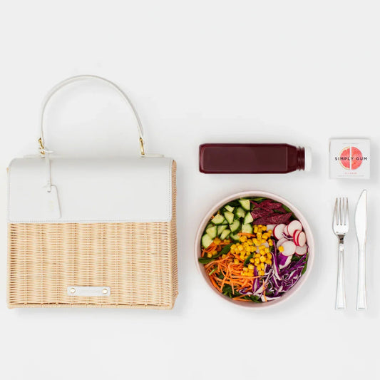 Chic insulated lunch bag with salad bowl, juice bottle, gum, and cutlery on white background