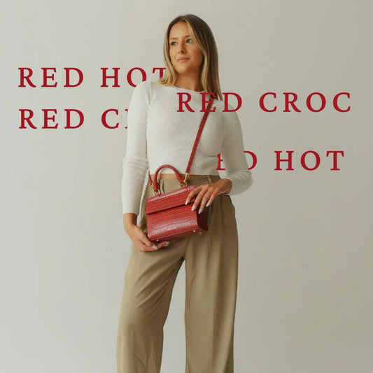 Woman holding a red croc-embossed vegan leather lunch bag, stylish and professional