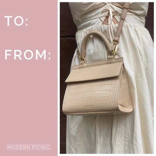Beige vegan leather lunch bag with crocodile texture, crossbody strap, and gold hardware.