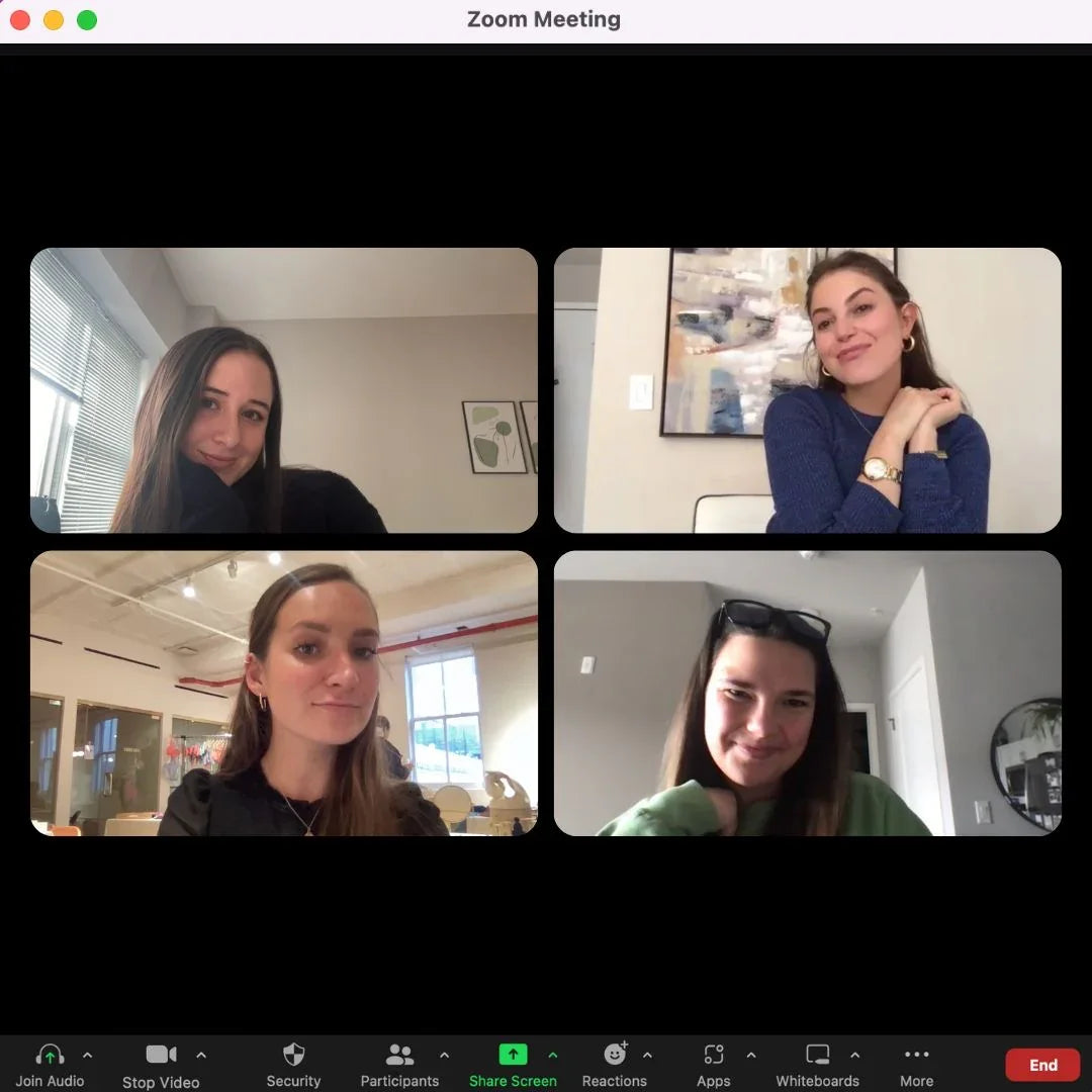 Four women on a video conference call, smiling in home and office settings.