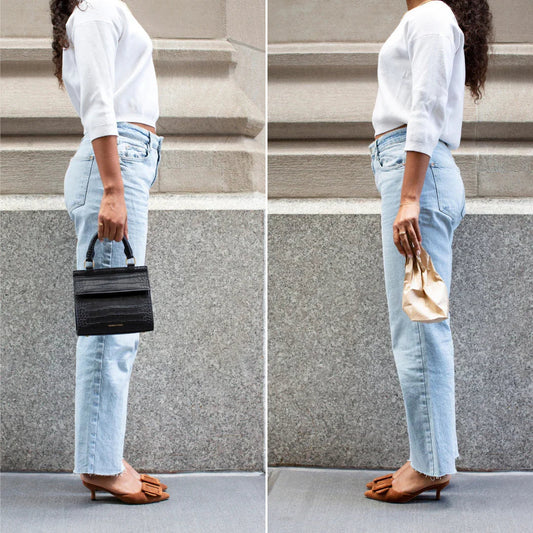 Woman in casual outfit holding black vegan leather lunch tote and brown paper bag side by side