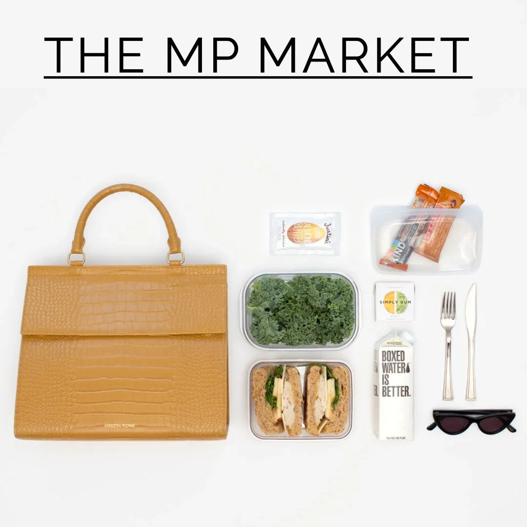 Chic tan insulated lunch bag with healthy lunch containers, utensils, water, and snacks on white background.