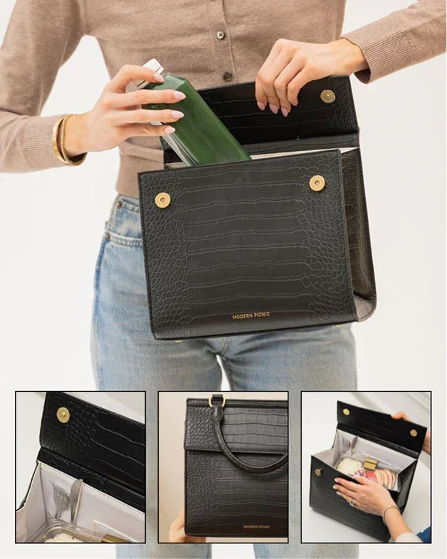 Black croc-textured insulated lunch tote with gold accents, holding a green bottle, ideal for work or travel.