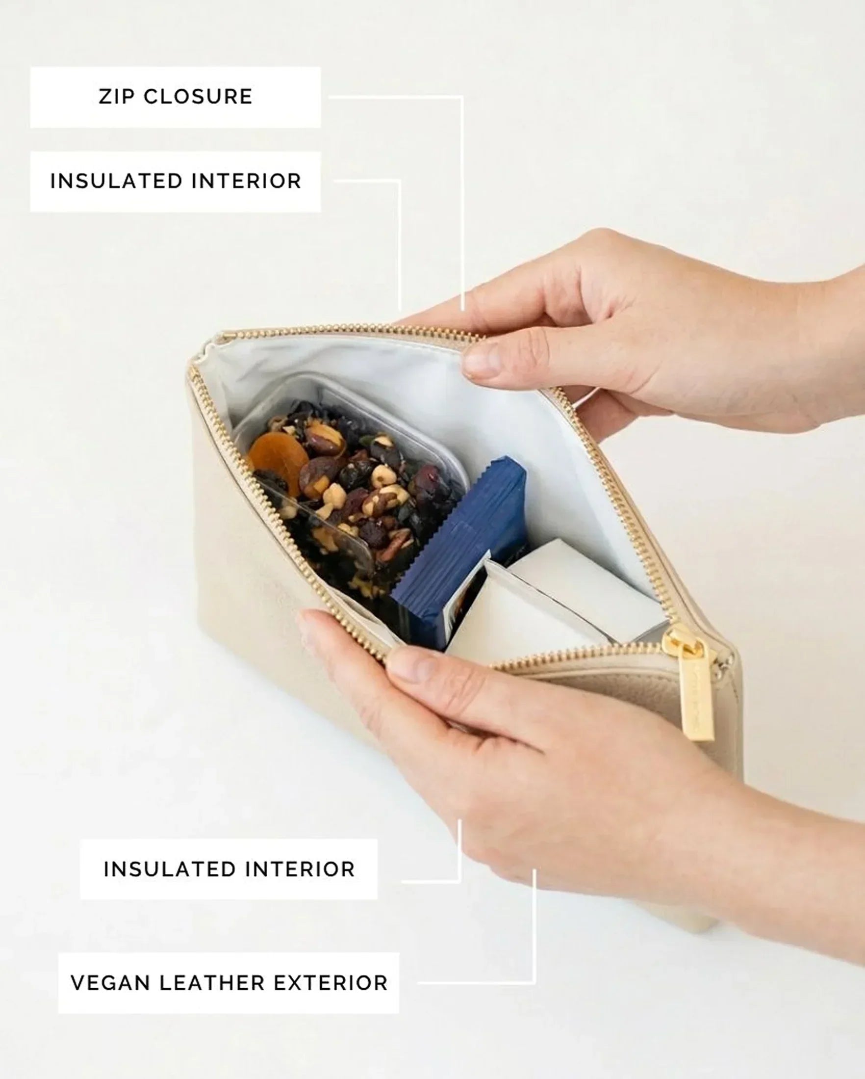 Vegan leather lunch bag with insulated interior, zip closure, holding snacks and tea bags