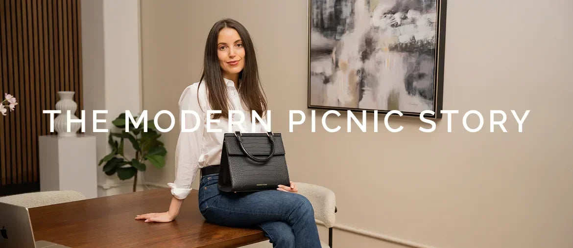 Woman holding chic black insulated lunch bag, stylish vegan leather tote for work and travel