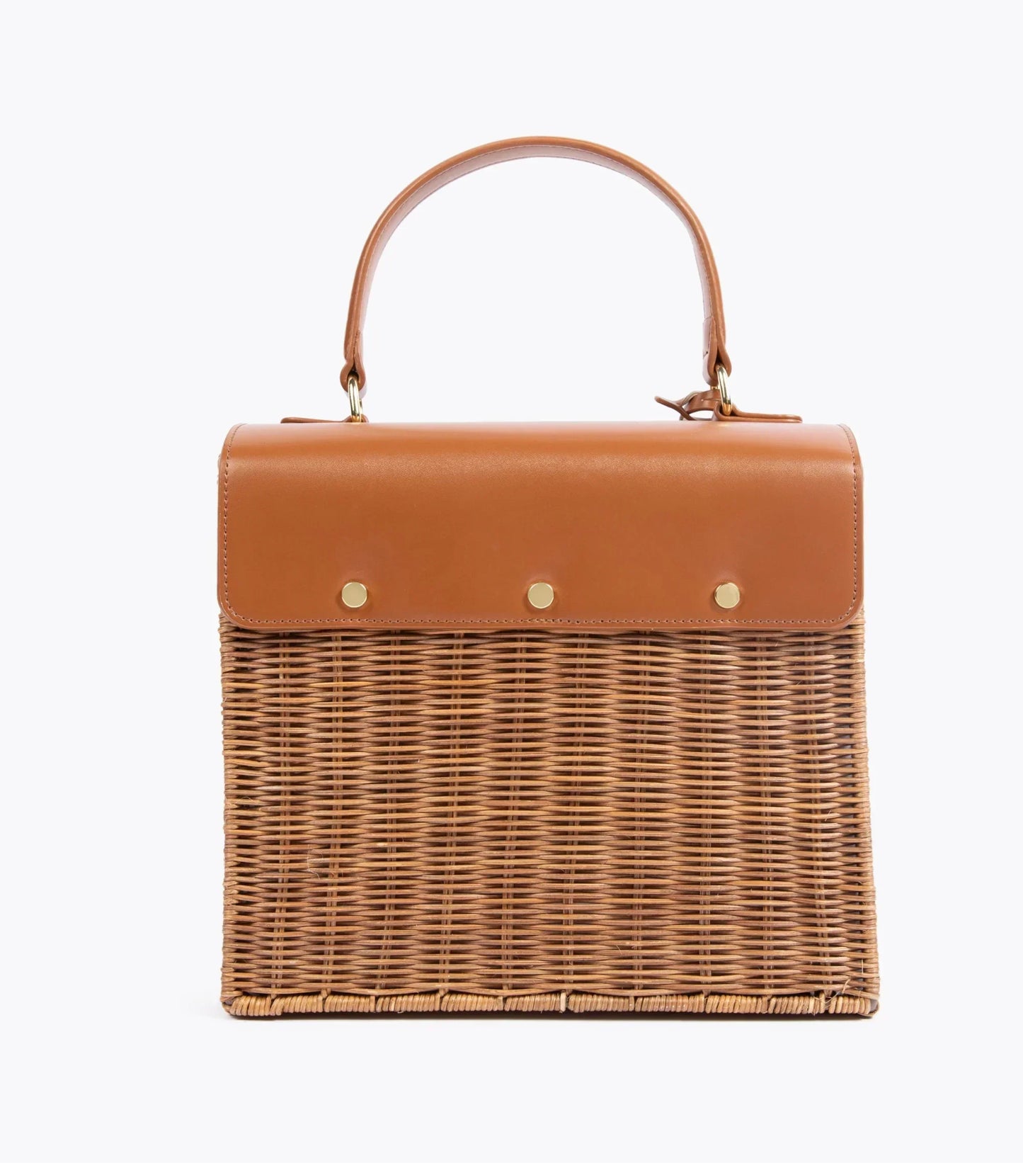 A back view of the structured picnic-style handbag. The bottom two-thirds of the bag are made of brown woven wicker, and the top flap is smooth brown vegan leather. The back of the leather flap is secured to the wicker body with three visible gold-tone fasteners.