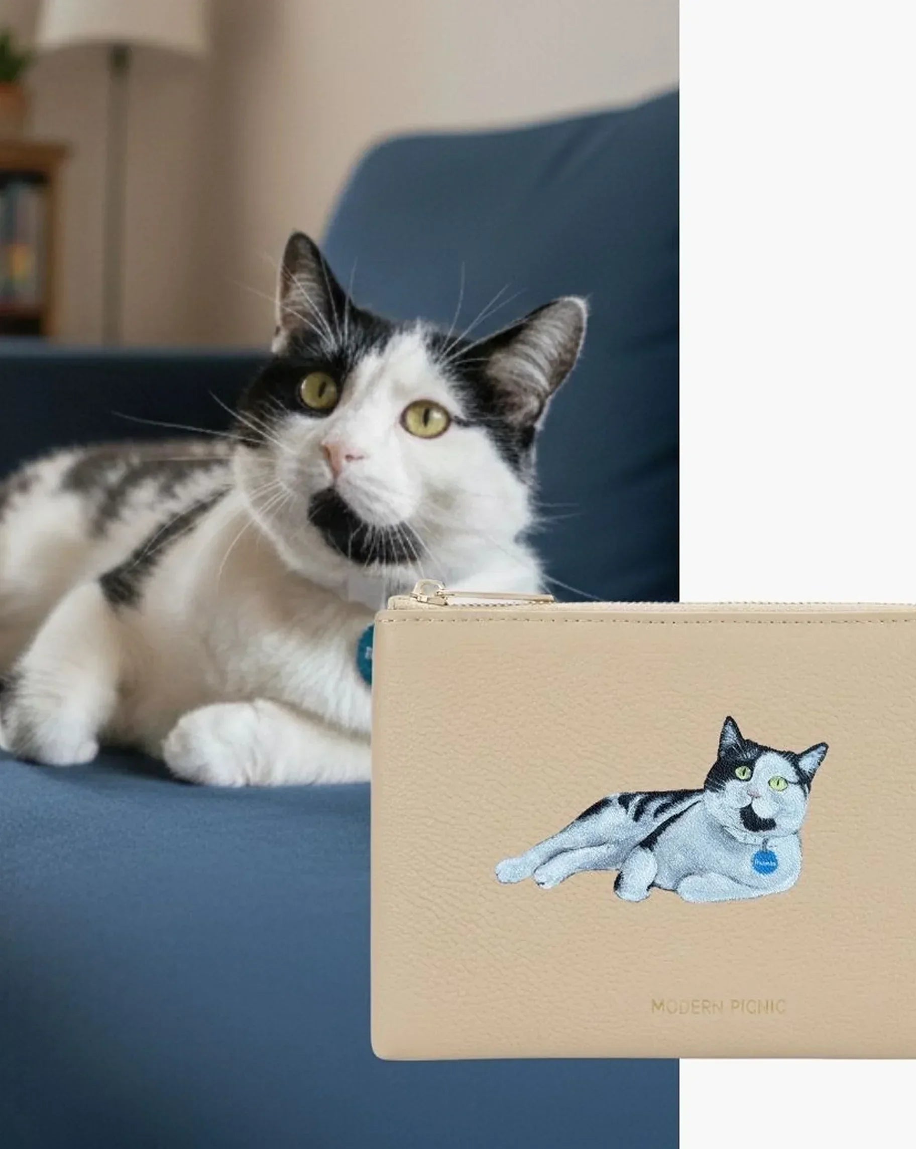 Beige vegan leather pouch with embroidered cat, matching real cat on blue couch