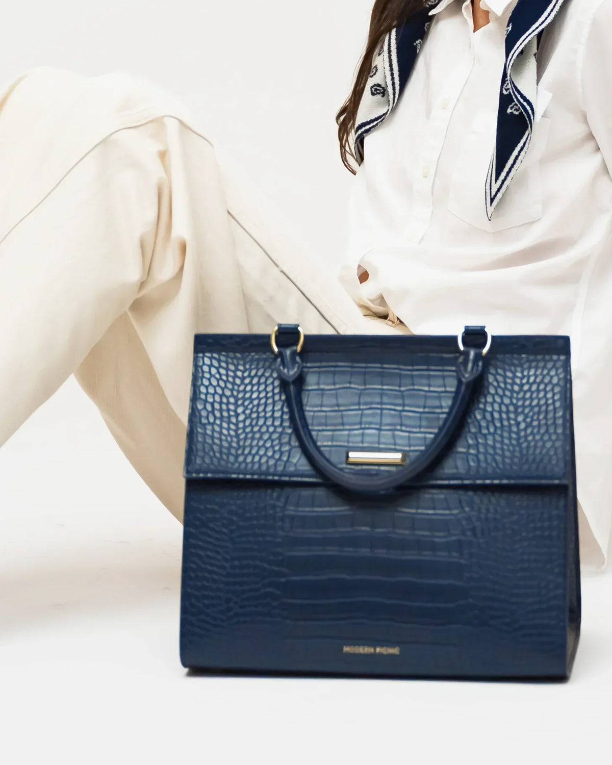 Navy blue croc-embossed vegan leather lunch bag with top handles.