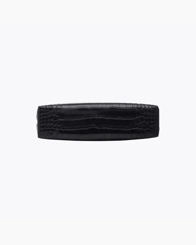 A view of the flat, rectangular base of the small black pouch, showing the crocodile-embossed texture.