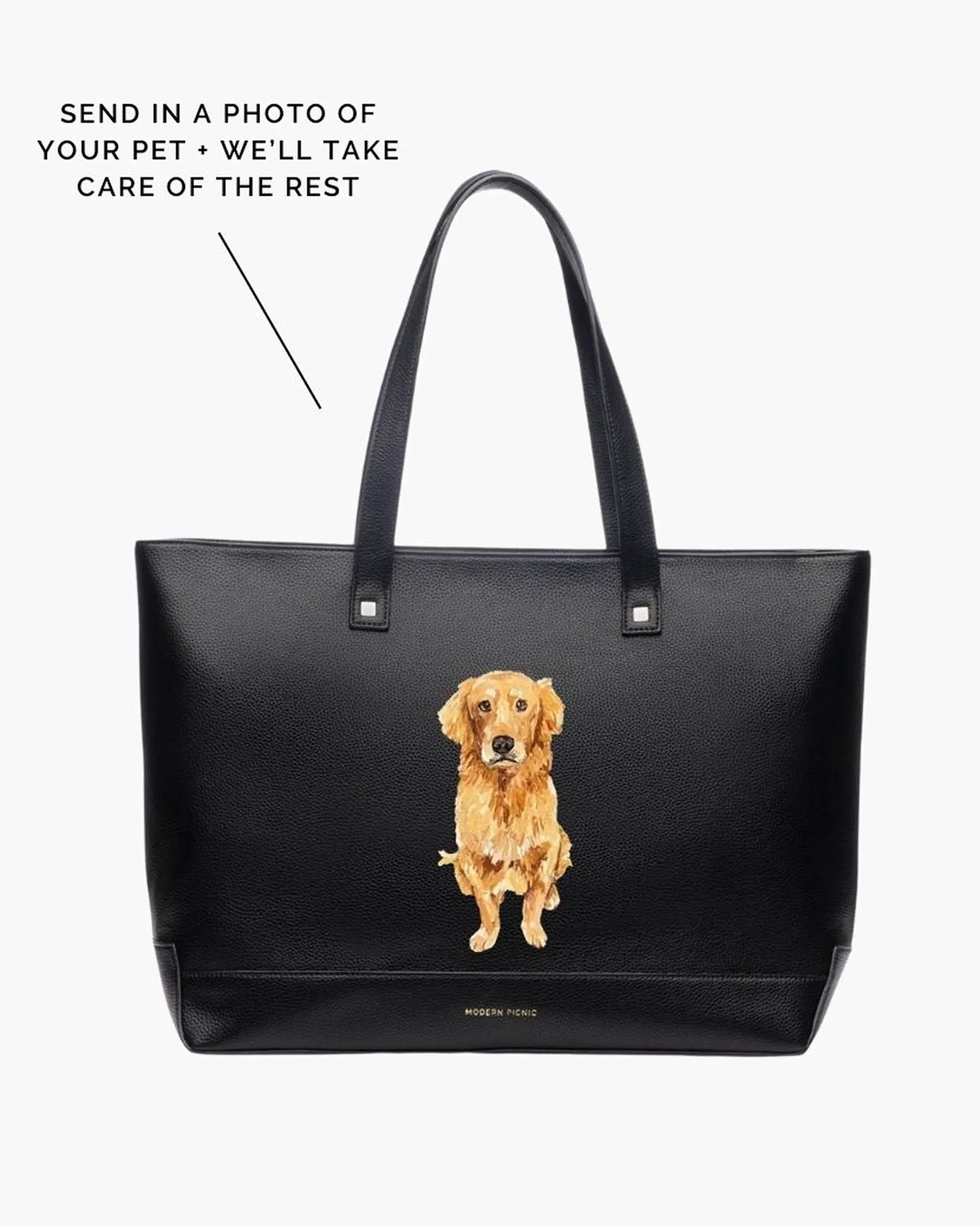 Black vegan leather tote with custom pet portrait of a golden retriever on front, white background.
