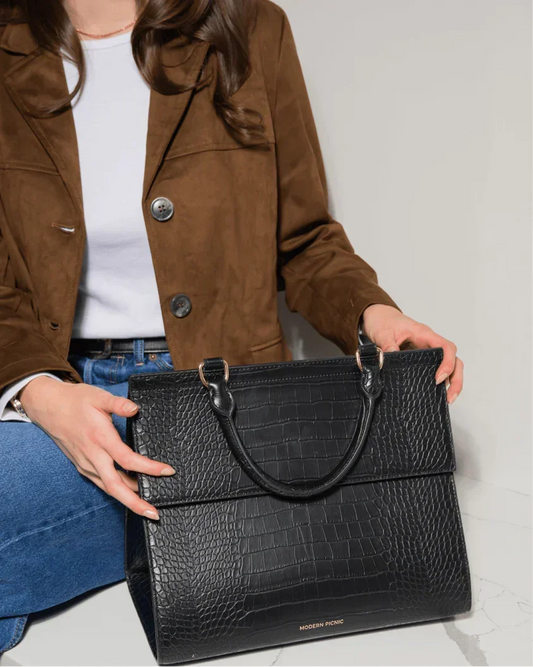 Black croc-texture vegan leather tote bag with top handles, styled for work or travel